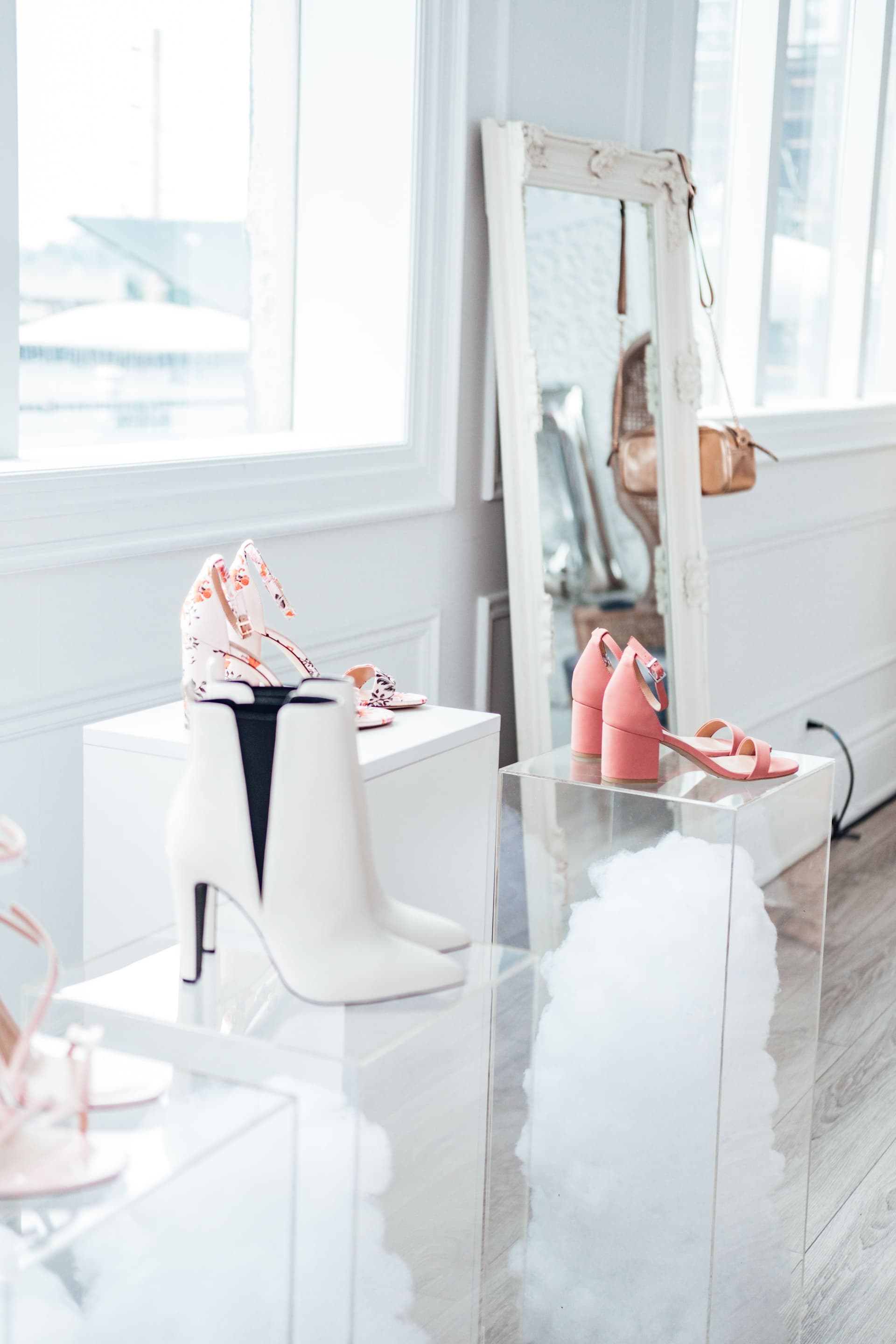 Modern shoe collection elegantly displayed in a chic boutique with natural lighting.